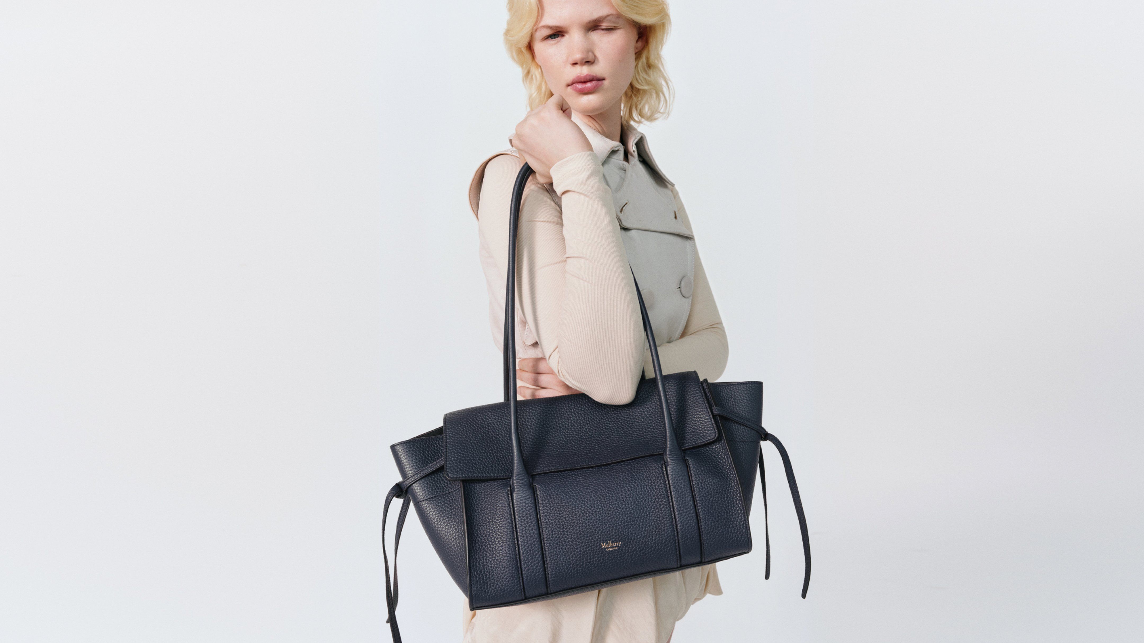 Model wearing the Mulberry Soft Bayswater handbag in navy leather